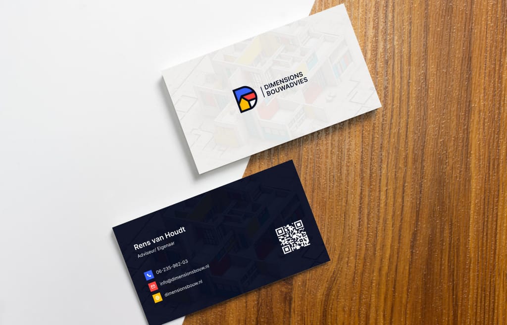 Dimensions Bouwadvies business cards on a wooden surface, showing the geometric D monogram and the dark reverse side