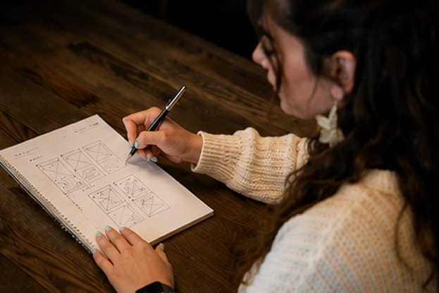 Nata van Houdt sketching wireframes in a notebook