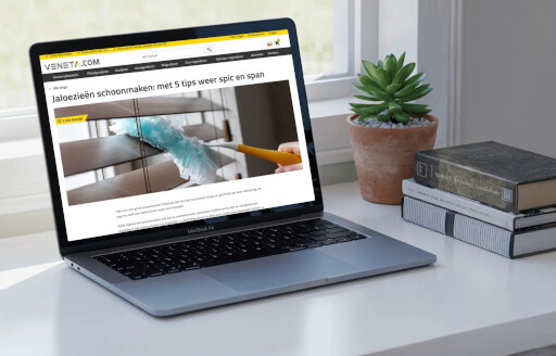 Veneta.com storefront shown on a laptop beside a plant